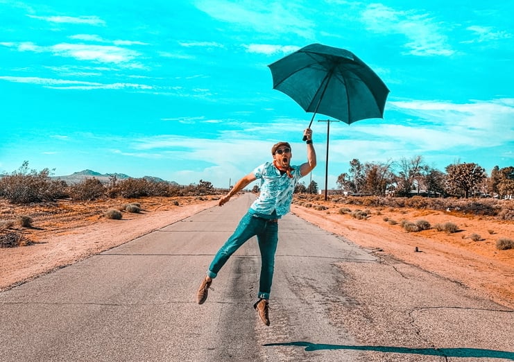 joshua-coleman-wh5L9SOdkis-unsplash_road_jump_umbrella_sky_crop